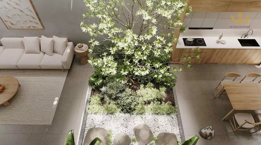 Khoảng thông tầng giữa nhà giúp tối ưu ánh sáng và gió trời tự nhiên. Tiểu cảnh cây xanh bên dưới cho không gian càng sống động hơn.